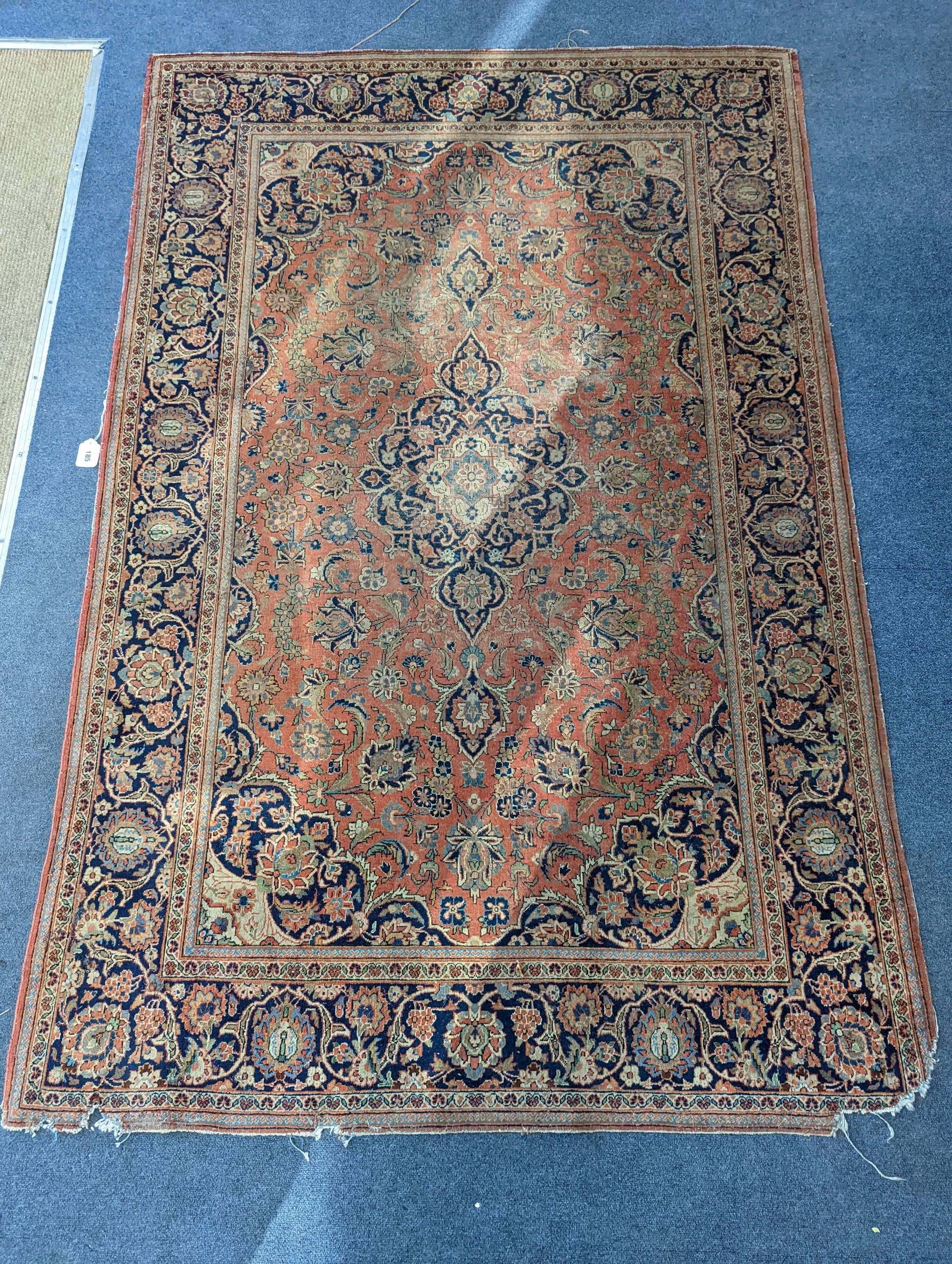 A Kashan red ground rug, 200 x 132cm